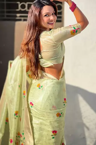 Green with multicolor accents  woven zari floral motifs work
 paithani style saree  with blouse piece