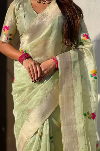 Green with multicolor accents  woven zari floral motifs work
 paithani style saree  with blouse piece