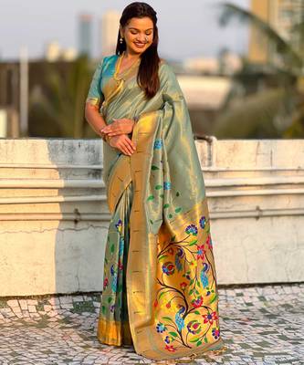 Light green with multicolor accents  woven zari floral & peacock motifs  silk blend   1