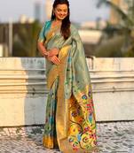 Light green with multicolor accents  woven zari floral & peacock motifs  silk blend  