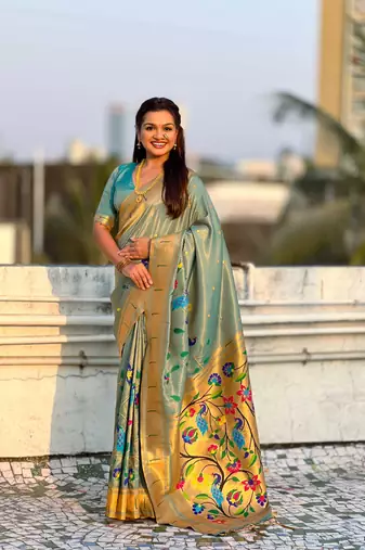 Light green with multicolor accents  woven zari floral & peacock motifs  silk blend  
