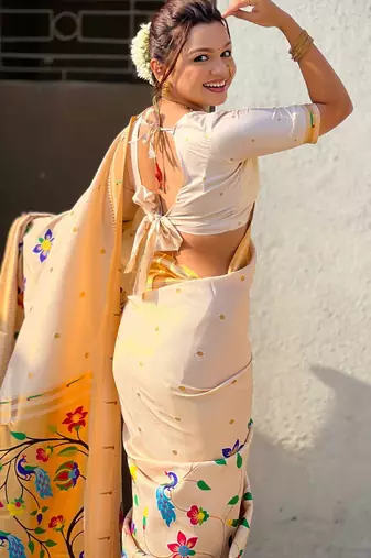 Off white with multicolor accents  woven zari floral & peacock motifs  silk blend