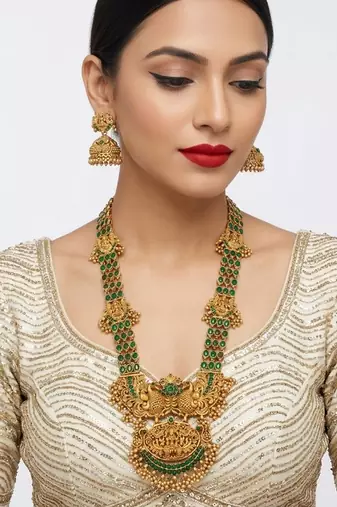 Stunning gold-plated temple jewelry set with emeralds | traditional haram & jhumkas | bridal & festival wear