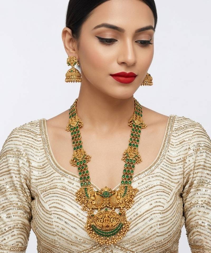 Stunning gold-plated temple jewelry set with emeralds | traditional haram & jhumkas | bridal & festival wear