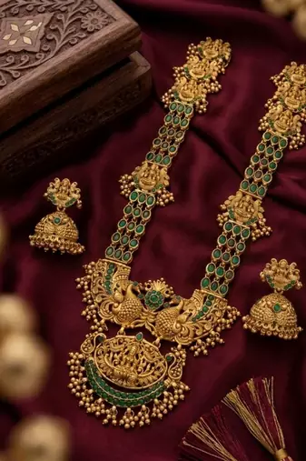 Stunning gold-plated temple jewelry set with emeralds | traditional haram & jhumkas | bridal & festival wear