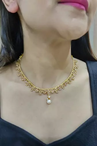 gold polki necklace set with pearl drop and matching earrings