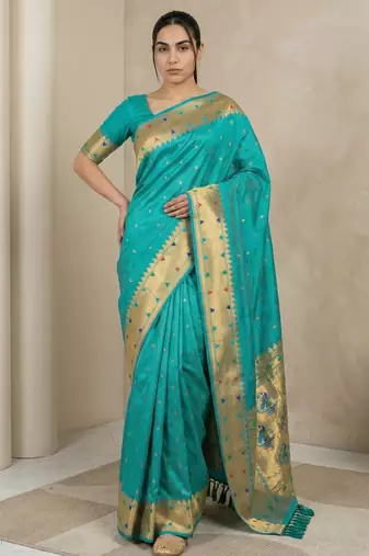 Sky blue with gold border contrast traditional peacock & triangle motifs work silk blend fabric rich ethnic festive wear