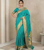 Sky blue with gold border contrast traditional peacock & triangle motifs work silk blend fabric rich ethnic festive wear