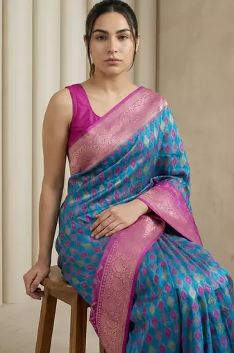 Teal geometric diamond weave pattern rich zari woven border & pallu silk blend fabric elegant festive & traditional wear