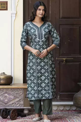 Green color cotton blended floral printed partywear suit