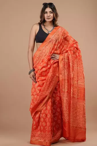 Orange maheshwari silk saree with woven borders and beautiful hand block print