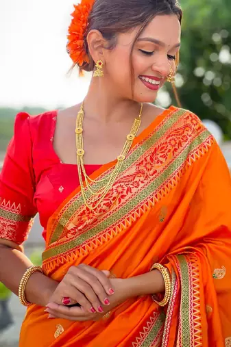 Orange elegant art silk woven saree with rich zari border