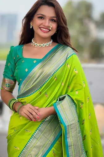 Green elegant art silk woven saree with rich zari border