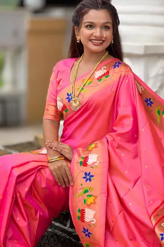 Peach elegant art silk woven saree with rich zari border
