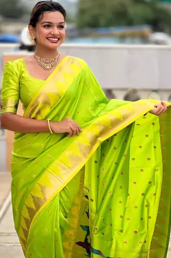 Green elegant art silk woven saree with rich zari border