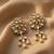 white alloy earrings with kundan pearl layered chandelier