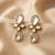 white alloy earrings with kundan pearl drop floral work