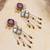purple alloy earrings with kundan pearl work design