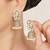 white alloy jhumki with kundan pearl floral work
