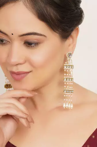 white alloy earrings with kundan pearl drop work