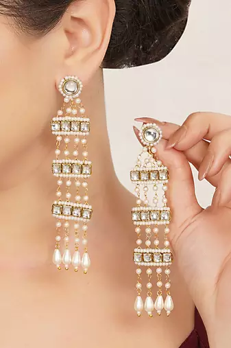 white alloy earrings with kundan pearl drop work