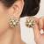 white alloy earrings with mini kundan flower work