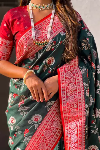 Dark green woven self design pure silk banarasi saree with blouse