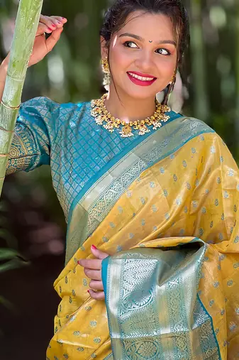 Yellow woven self design embellished tissue kanjivaram saree with blouse