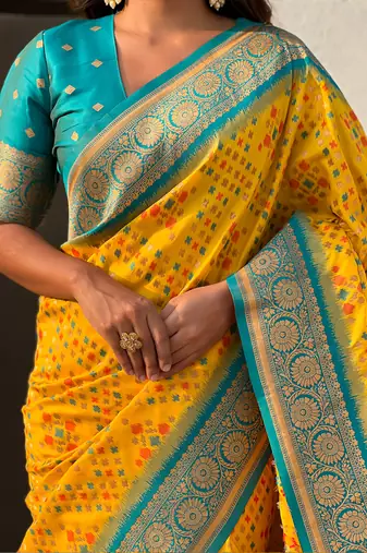 Yellow woven self design silk blend patola saree with blouse