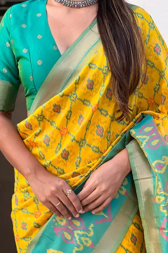 Yellow woven self design silk blend patola saree with blouse