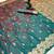 Teal soft silk saree with butti design & floral zari border