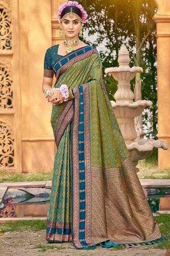 Rich and ethnic looking green color woven soft silk saree
