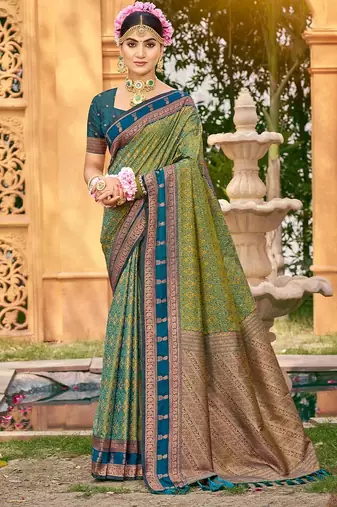 Rich and ethnic looking green color woven soft silk saree