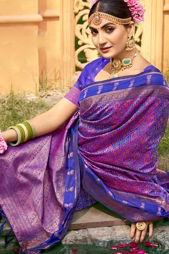 Rich and ethnic looking purple woven soft silk blend saree