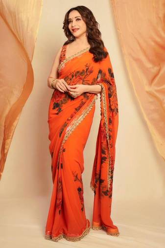 Orange floral printed saree with large floral prints and lace border