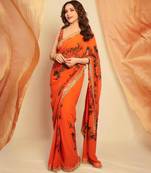 Orange floral printed saree with large floral prints and lace border