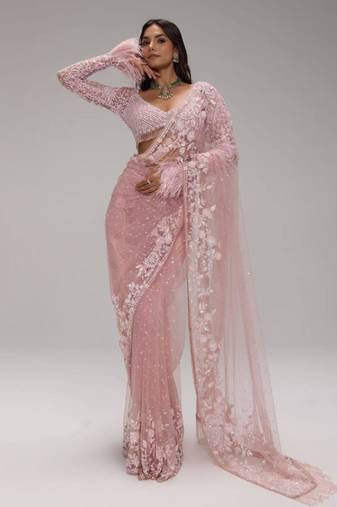 Pink embroidered net saree with feather-trimmed blouse and tassel detail