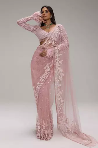 Pink embroidered net saree with feather-trimmed blouse and tassel detail