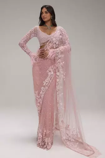 Pink embroidered net saree with feather-trimmed blouse and tassel detail