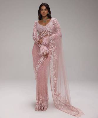 Pink embroidered net saree with feather-trimmed blouse and tassel detail 3
