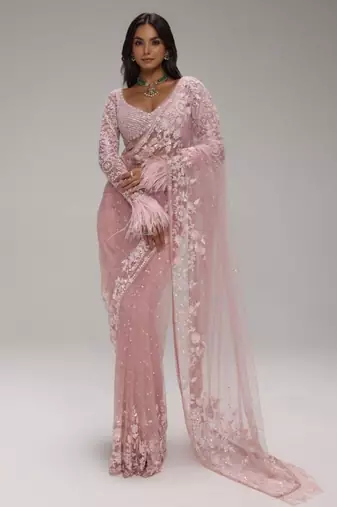 Pink embroidered net saree with feather-trimmed blouse and tassel detail