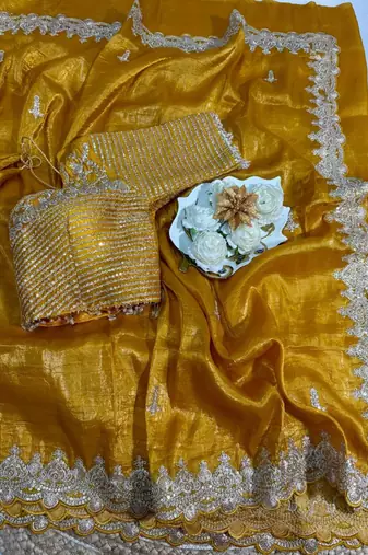 Yellow silk blend saree with scalloped zari border and striped blouse