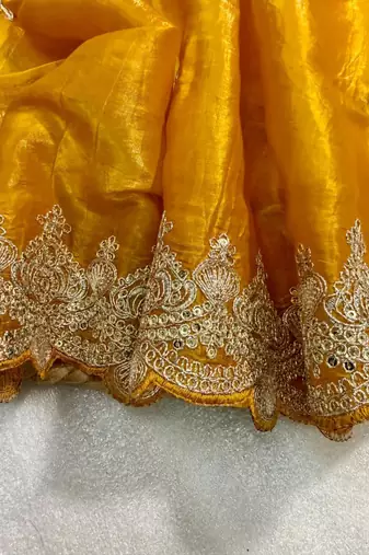 Yellow silk blend saree with scalloped zari border and striped blouse