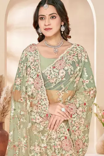 Dusty pista color net resham embroidered & zircon work saree