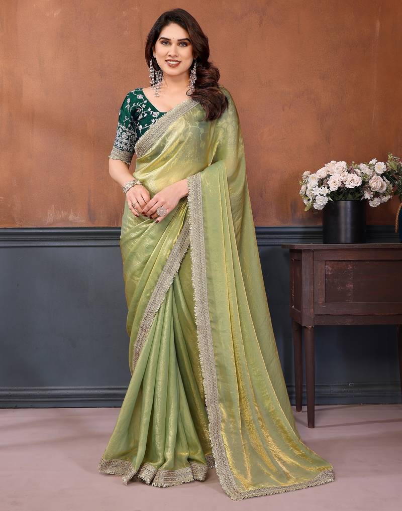 Light green fandy satin saree with embroidered lace border and matching blouse piece