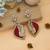 Red color american diamond earrings