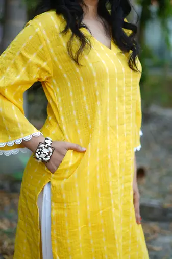 yellow cotton kurti pant set with kantha work design