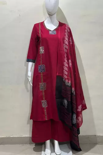 Beautiful jaipuri a red cotton straight kurta set adorned with traditional patch work and hand katha work.