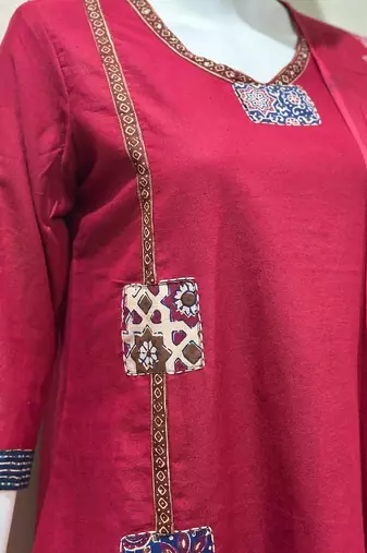 Beautiful jaipuri a red cotton straight kurta set adorned with traditional patch work and hand katha work.