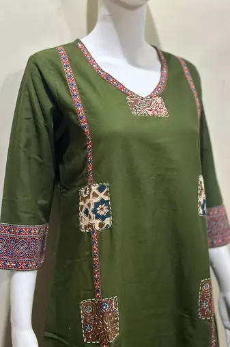 Beautiful jaipuri a dark green cotton straight kurta set adorned with traditional patch work and hand katha work.